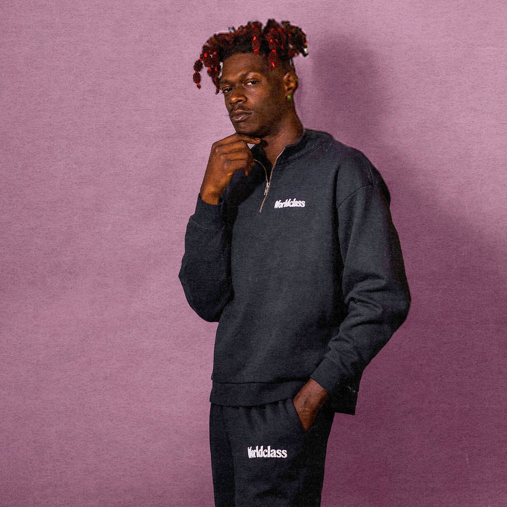 Person wearing a black tracksuit with 'Worldclass' branding on a purple background